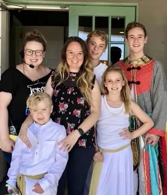 Rebekah Mackie backstage with cast members in costume
